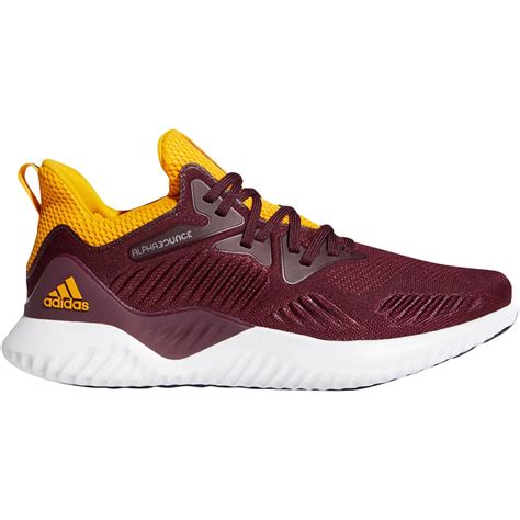 maroon and gold adidas shoes.